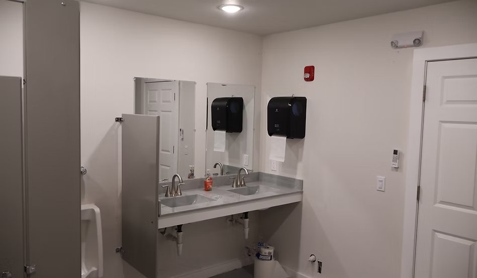 Men's and women's bathrooms at CrossFit Inola